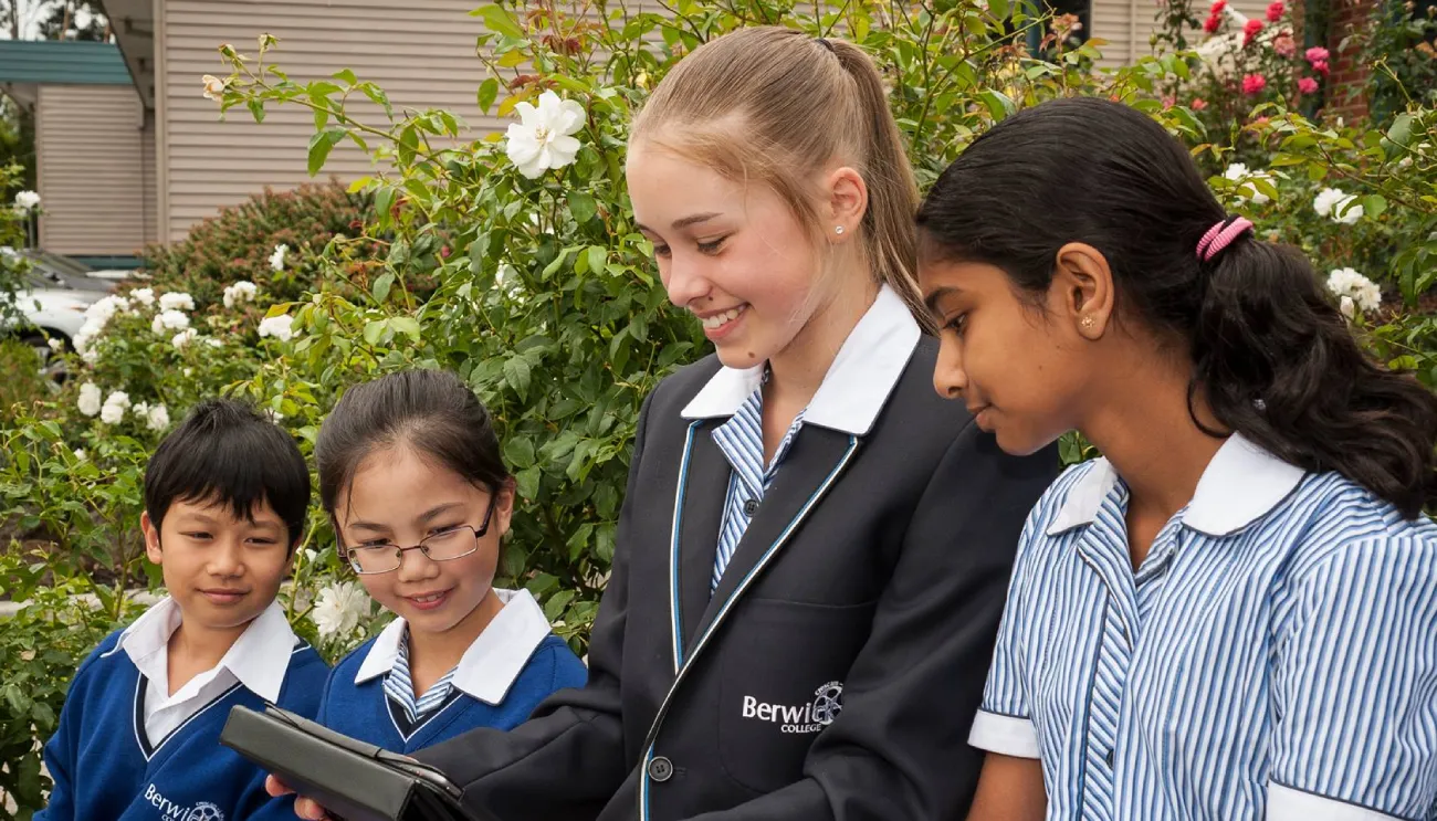 Students looking at new Laptops together
